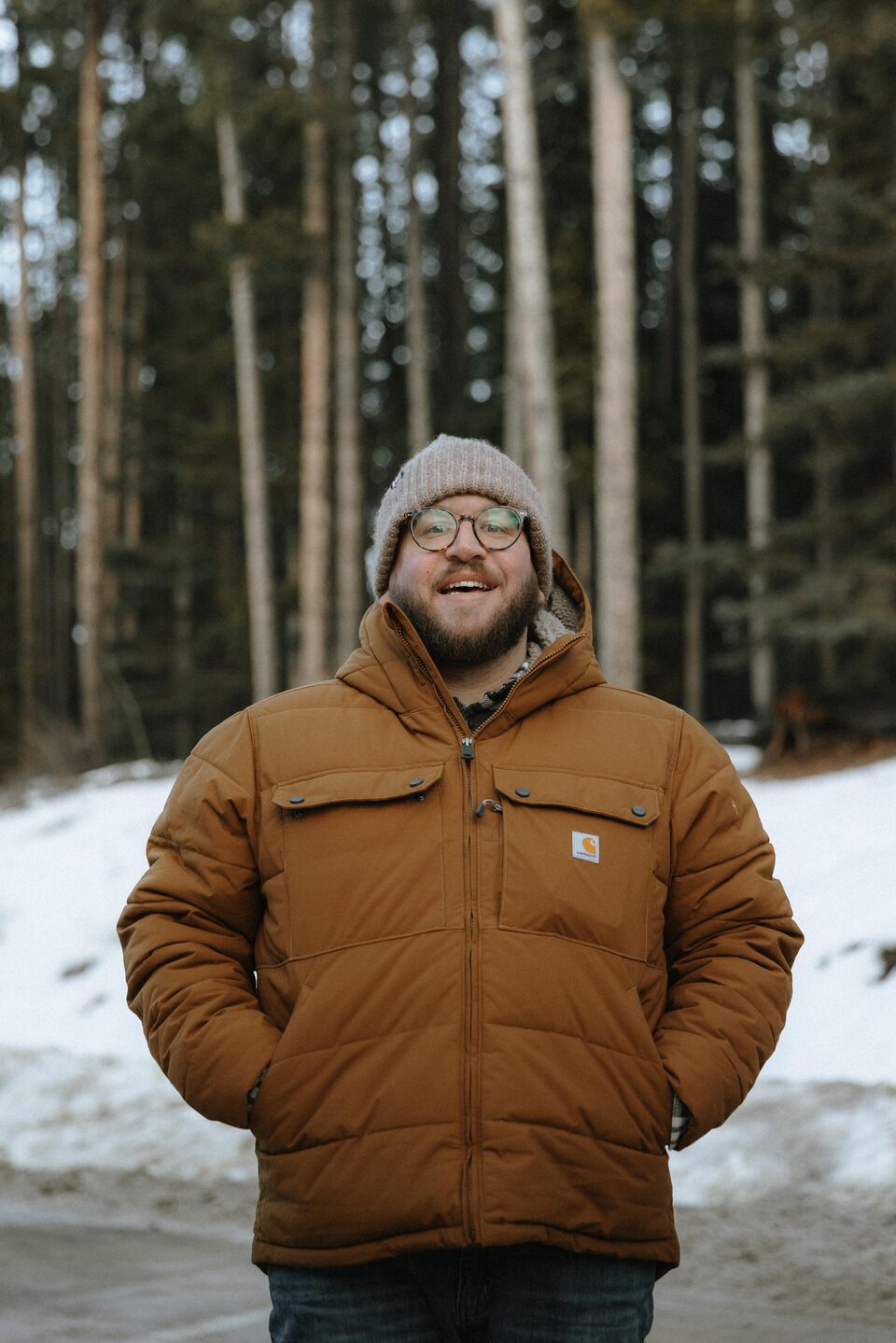 Dustin Stephens standing in a snowy pine forest